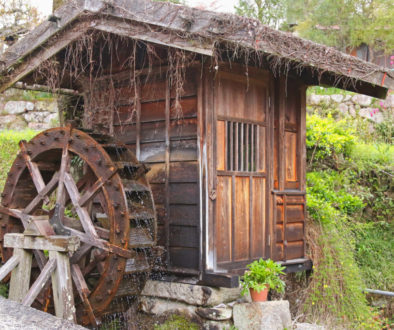 Traditional wooden water wheel spinning at Tsumago - juku in Tsu